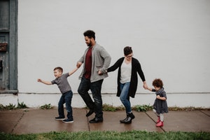 Photo of family walking while holding hands