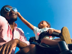 Happy dad and child interacting on sunny day