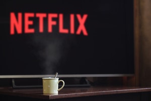 Mug of warm drink sitting in front of TV with Netflix
