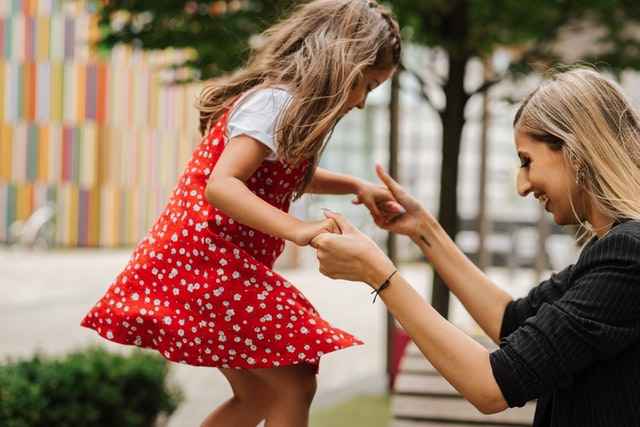 Mom playing with daughter at park