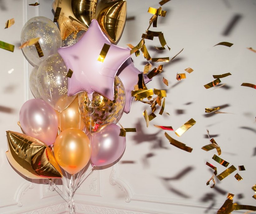 Trendy metallic birthday balloons and confetti