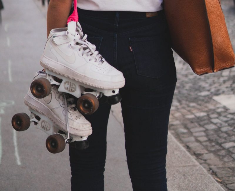 Worn out roller skate wheels on white skates